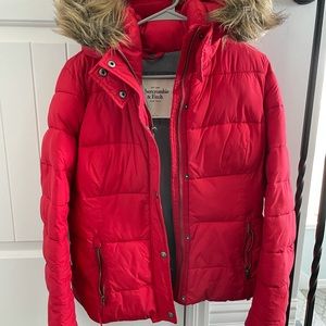 Abercrombie and Fitch women’s red puffer jacket with fur hood.